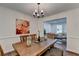 Bright dining area with wooden table, stylish decor, and easy access to the living room at 655 Barrington Way, Roswell, GA 30076