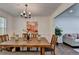 Cozy dining space with a rustic wooden table, modern decor, and a vibrant art piece at 655 Barrington Way, Roswell, GA 30076