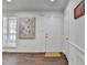 Bright entryway featuring a white front door, hardwood floors, and fresh paint at 655 Barrington Way, Roswell, GA 30076