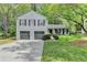 Charming two-story home with a two-car garage, landscaped yard, and covered front porch at 655 Barrington Way, Roswell, GA 30076