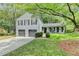 Charming two-story home with a two-car garage, landscaped yard, and covered front porch at 655 Barrington Way, Roswell, GA 30076