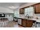 Bright kitchen with wood cabinets, stainless steel appliances, and a view of the living area at 655 Barrington Way, Roswell, GA 30076
