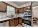 Kitchen featuring stainless steel appliances, wood cabinets, and natural light at 655 Barrington Way, Roswell, GA 30076