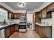 Open kitchen with wood floors, stainless appliances, and a view into the dining room at 655 Barrington Way, Roswell, GA 30076