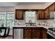 Well-lit kitchen showcasing stainless steel appliances, granite countertops, and wood cabinetry at 655 Barrington Way, Roswell, GA 30076