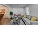 Bright living room with hardwood floors, modern decor, and an open layout to the dining area at 655 Barrington Way, Roswell, GA 30076