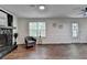 Spacious living room featuring a stone fireplace and hardwood floors at 655 Barrington Way, Roswell, GA 30076