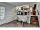 Bright living room featuring hardwood floors, and a view of the kitchen and stairs at 655 Barrington Way, Roswell, GA 30076