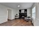 Inviting living room featuring hardwood floors, a fireplace, and bright windows at 655 Barrington Way, Roswell, GA 30076