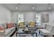 Bright living room boasts a sofa, accent chair, and a stylish coffee table with decor at 655 Barrington Way, Roswell, GA 30076