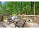 Wooden deck with outdoor seating, surrounded by lush green trees, offering a peaceful retreat at 1188 Cedar Park Cir, Stone Mountain, GA 30083