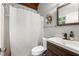 Cozy bathroom with white shower curtain, a dark-stained wood cabinet sink, and modern fixtures at 1188 Cedar Park Cir, Stone Mountain, GA 30083