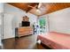 Spacious bedroom with a wood ceiling, a large dresser, and a sliding door leading to the outside at 1188 Cedar Park Cir, Stone Mountain, GA 30083