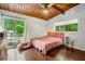 Bright bedroom with wood ceiling, sliding door access to an outdoor balcony, and hardwood floors at 1188 Cedar Park Cir, Stone Mountain, GA 30083