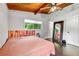 Comfortable bedroom with wood ceiling, large mirror, and sliding door access to the outdoors at 1188 Cedar Park Cir, Stone Mountain, GA 30083