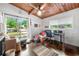 Bright bedroom with wood ceiling, sitting area, and sliding door access to an outdoor balcony at 1188 Cedar Park Cir, Stone Mountain, GA 30083