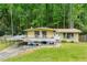Unique home with a large deck and carport, nestled in a lush, wooded setting, providing privacy at 1188 Cedar Park Cir, Stone Mountain, GA 30083