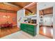 Inviting kitchen featuring a green island, wood ceilings, a skylight, and open access to the dining and entryway at 1188 Cedar Park Cir, Stone Mountain, GA 30083