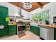 Well-appointed kitchen with farm sink, modern appliances, and ample counter space with colorful cabinetry at 1188 Cedar Park Cir, Stone Mountain, GA 30083