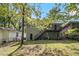 View of home's backyard with a deck and a lush, green lawn at 261 Hemphill School Nw Rd, Atlanta, GA 30331