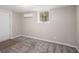 Finished basement featuring carpet flooring and a door, offering flexibility for various uses at 261 Hemphill School Nw Rd, Atlanta, GA 30331