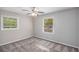 Neutral bedroom features two bright windows and ceiling fan with lighting at 261 Hemphill School Nw Rd, Atlanta, GA 30331