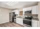 Cozy kitchen with stainless steel appliances, granite countertops, and white cabinetry at 261 Hemphill School Nw Rd, Atlanta, GA 30331