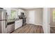 Well-lit kitchen with stainless steel appliances, granite countertops, and white cabinetry at 261 Hemphill School Nw Rd, Atlanta, GA 30331