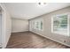 Open-concept living area featuring hardwood floors and ample natural light from the two large windows at 261 Hemphill School Nw Rd, Atlanta, GA 30331
