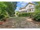 Backyard features manicured landscaping, mature trees, and a charming deck, creating a relaxing retreat at 4257 Edgewater Nw Dr, Kennesaw, GA 30144