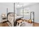 Bright bedroom with hardwood floors, a four-poster bed, and a window with natural light at 4257 Edgewater Nw Dr, Kennesaw, GA 30144