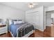 Cozy bedroom with hardwood floors, a white bed frame, and a closet for ample storage at 4257 Edgewater Nw Dr, Kennesaw, GA 30144