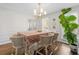 Bright dining area featuring stylish seating, a contemporary chandelier, and a large potted plant at 4257 Edgewater Nw Dr, Kennesaw, GA 30144