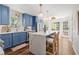 Bright kitchen with blue cabinets, stone countertop island, stainless appliances, and hardwood floors at 4257 Edgewater Nw Dr, Kennesaw, GA 30144
