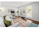 Bright living room has modern decor, a comfortable workspace, and large windows at 4257 Edgewater Nw Dr, Kennesaw, GA 30144