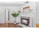 Inviting fireplace featuring a brick surround and white mantel, flanked by plants and decorative items at 4257 Edgewater Nw Dr, Kennesaw, GA 30144