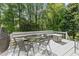 Outdoor seating area includes a table with chairs and a bench surrounded by lush greenery at 4257 Edgewater Nw Dr, Kennesaw, GA 30144