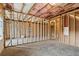 Unfinished basement with wooden framing and insulation offers potential for customization at 708 Dodd Ln # 156, Buford, GA 30518