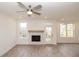 Living room with brick fireplace, multiple windows, and outdoor access to deck at 708 Dodd Ln # 156, Buford, GA 30518