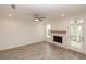 Cozy living room features fireplace, wood-look flooring, recessed lighting, and access to porch at 708 Dodd Ln # 156, Buford, GA 30518