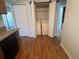 Convenient laundry area featuring a washer, dryer, folding doors, and stylish hardwood flooring at 114 Seasons Pkwy, Norcross, GA 30093
