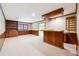 Spacious finished basement with a bar area, built-in shelving, and a cozy, carpeted space at 3200 Turtle Lake Se Ct, Marietta, GA 30067