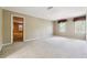 Large, carpeted bedroom with two windows and a glimpse into another room, creating an open feel at 3200 Turtle Lake Se Ct, Marietta, GA 30067