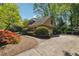 View of the brick home showing the side driveway and garage at 3200 Turtle Lake Se Ct, Marietta, GA 30067