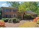 Beautiful brick home with green shutters, mature trees, and colorful landscaping at 3200 Turtle Lake Se Ct, Marietta, GA 30067