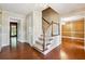 View of the foyer with hardwood floors, staircase and entryways to other rooms at 3200 Turtle Lake Se Ct, Marietta, GA 30067
