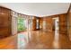 Elegant living room with hardwood floors, decorative wood paneling and large windows at 3200 Turtle Lake Se Ct, Marietta, GA 30067