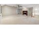 Open living room boasts a ceiling fan, neutral paint, cozy fireplace, and natural light at 3200 Turtle Lake Se Ct, Marietta, GA 30067