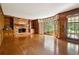 Cozy living room with a brick fireplace, wood paneling, and large windows at 3200 Turtle Lake Se Ct, Marietta, GA 30067