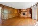 Elegant living room with hardwood floors, wood paneled wall, and brick fireplace with built-in bookshelves at 3200 Turtle Lake Se Ct, Marietta, GA 30067